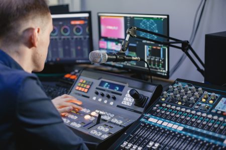 Brining together a skilled team to bring you the quality you deserve Sound engineer studio. Closeup view.